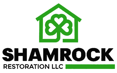 A green and black logo for shamrock restoration.